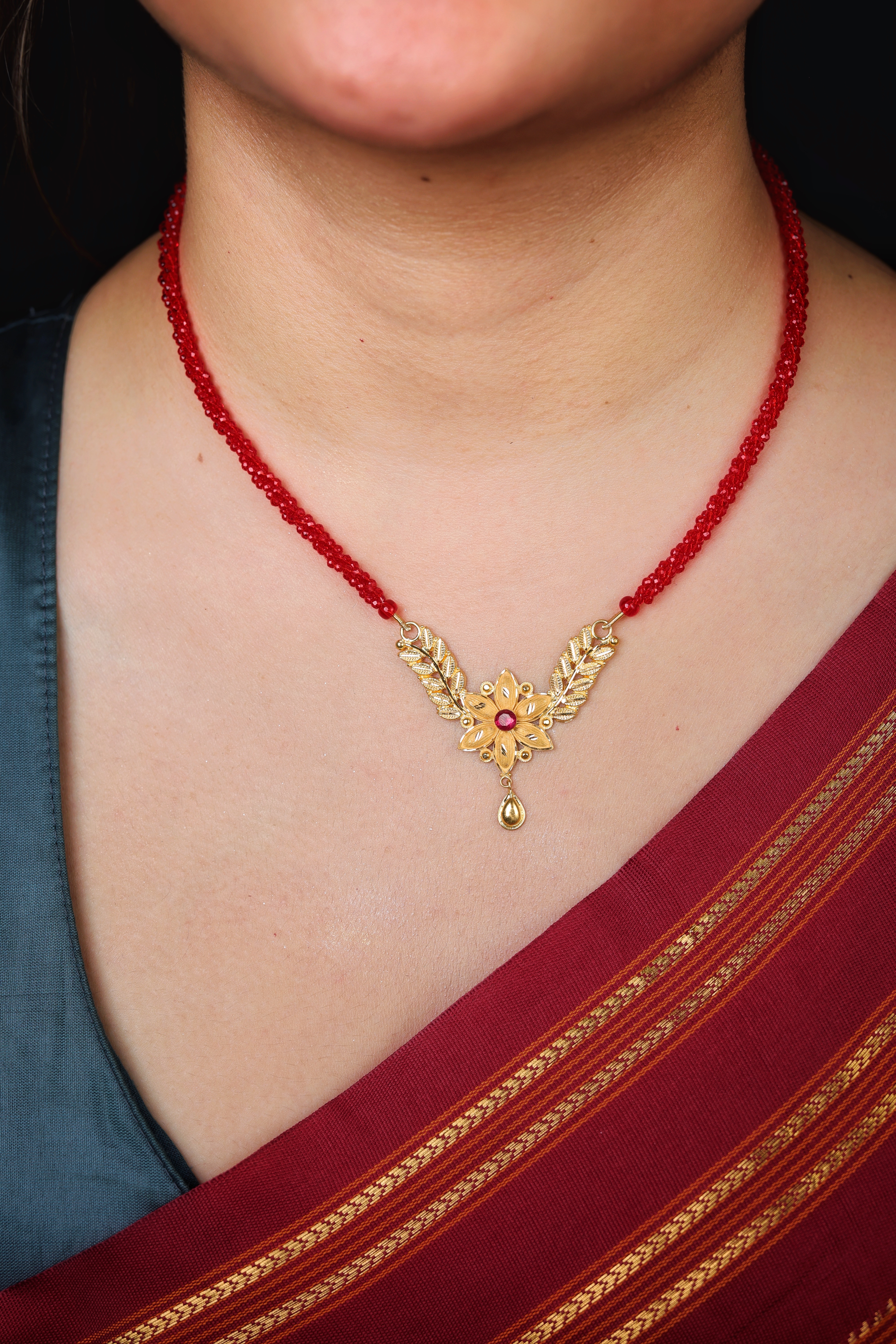 Decorative Floral Gold Pendant Mangal Sutra with Red Stone Accent