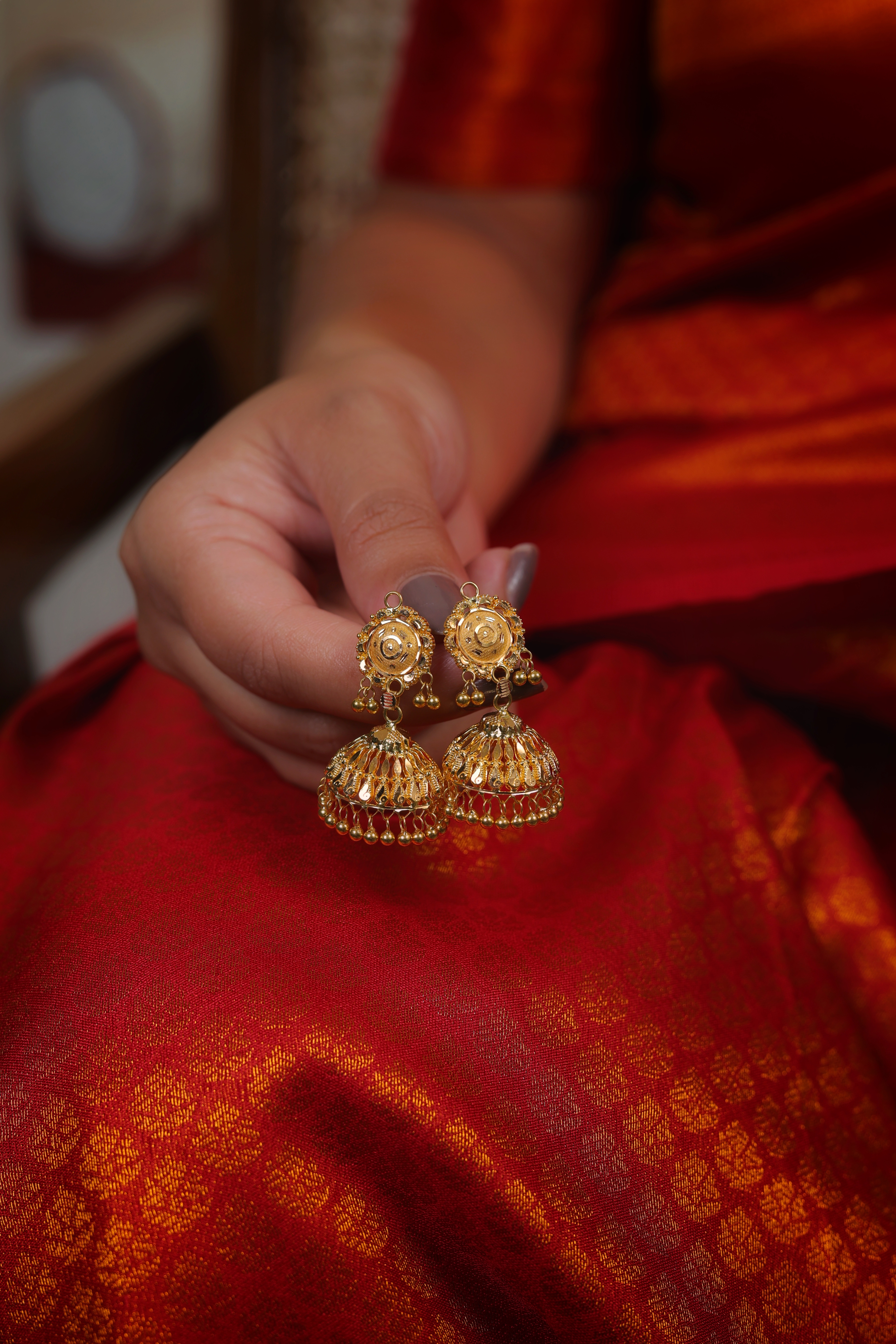 Ornate Sun-Medallion Gold Jhumki Earrings with Filigree Bell Drop