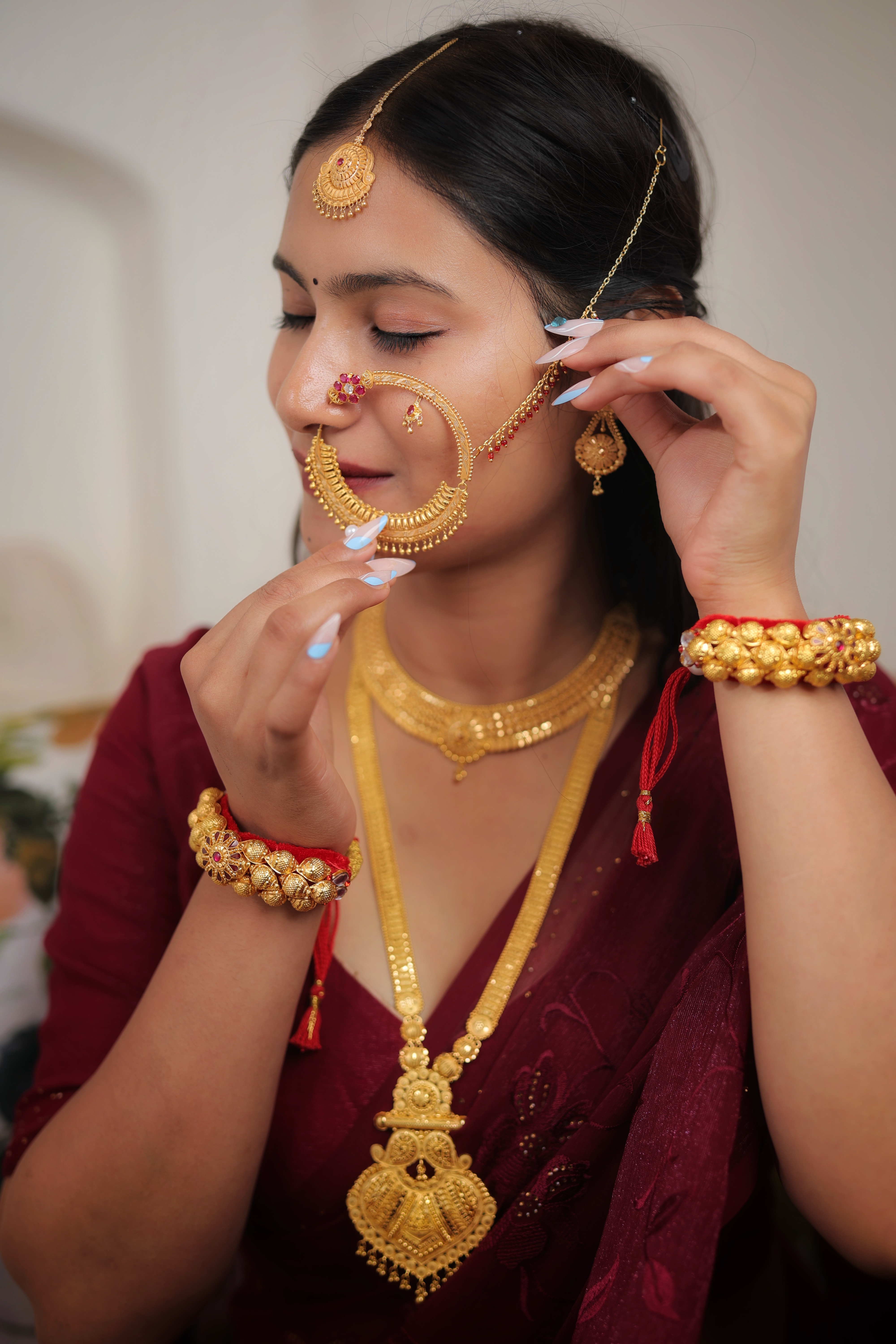 Traditional Bridal Gold Nath – Crescent Nose Ring with Red Stone & Pearl Detailing